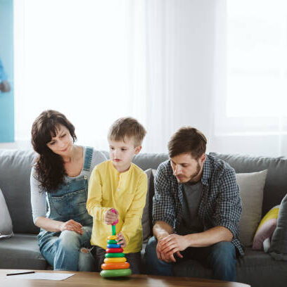 Parents and therapist are sitting on the couch during a meeting about their child